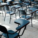 Rows of empty desks in a bright Buenos Aires classroom, symbolizing education and learning environment.